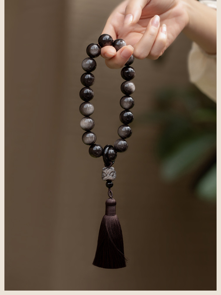 Muyun~Natural silver obsidian lion awakening holding rosary